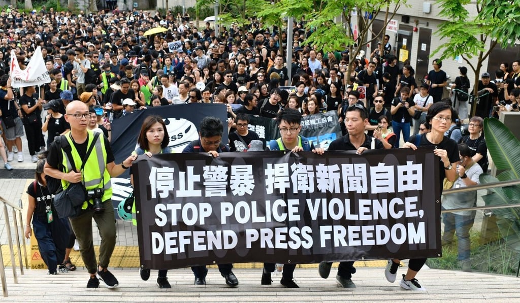 The Hong Kong Journalists Association hosts a silent march against police violence during protests in July last year. Photo: Warton Li