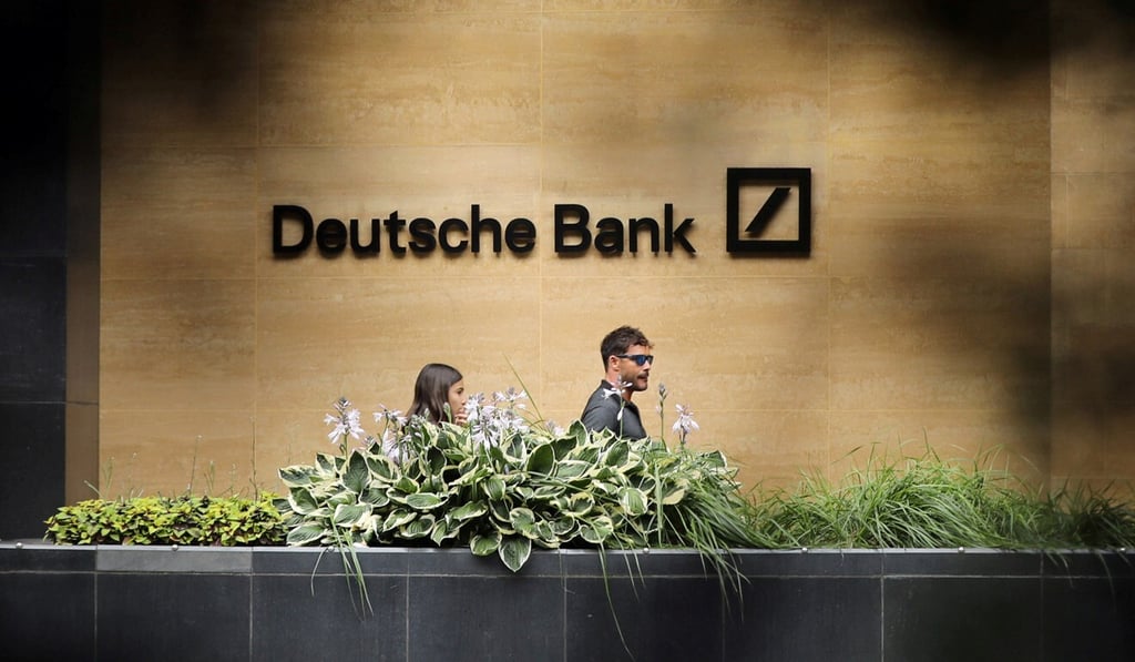 People walk past a Deutsche Bank office in London in July 2019. Photo: Reuters People walk past a Deutsche Bank office in London in July 2019. Photo: Reuters