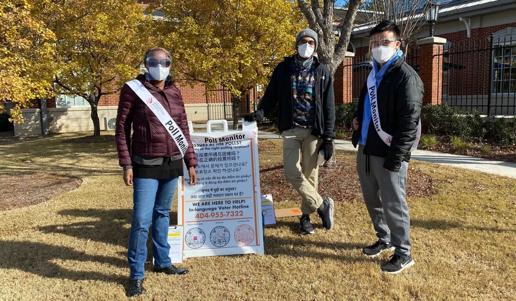 Asian Americans Advancing Justice (AAJC) poll monitors with a sign offering assistance in various languages, including Vietnamese and Hindi, in Georgia. Credit: James Woo