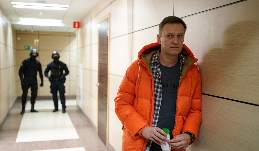 Russian opposition leader Alexei Navalny stands near law enforcement agents in a business centre in Moscow. Photo: December 2019