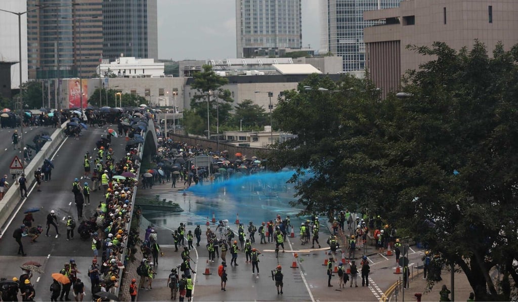 Police use a water cannon on protesters on August 31 last year. Photo: Xiaomei Chen