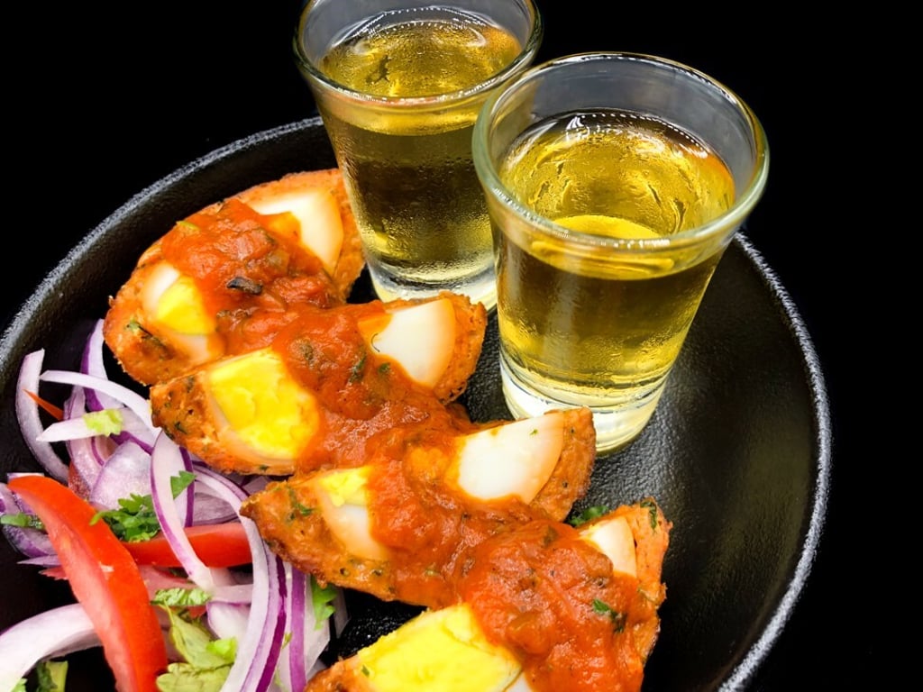 Colonel’s Scotch eggs featuring spiced lamb and a shot of whisky, served at Gunpowder. Photo: Handout