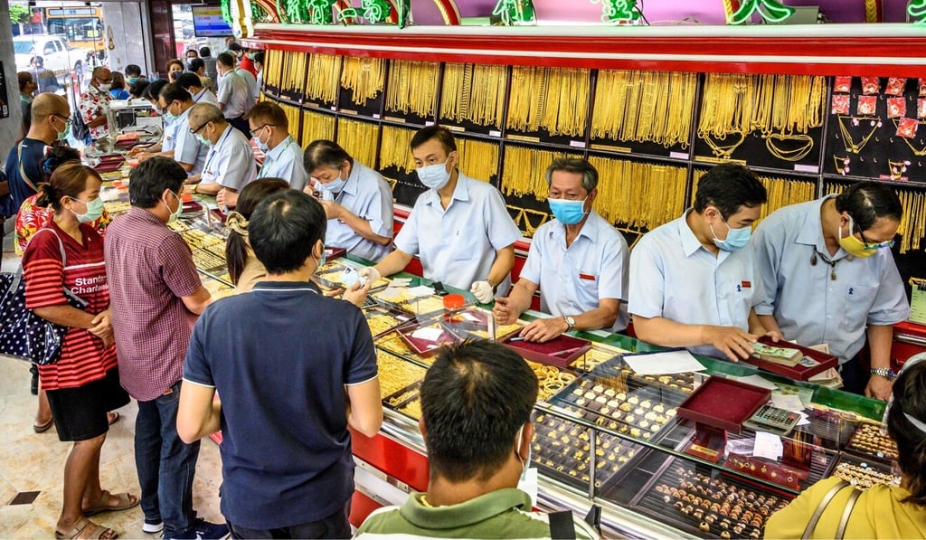 People sell their jewellery in a gold shop in Bangkok's Chinatown. File photo: AFP People sell their jewellery in a gold shop in Bangkok's Chinatown. File photo: AFP