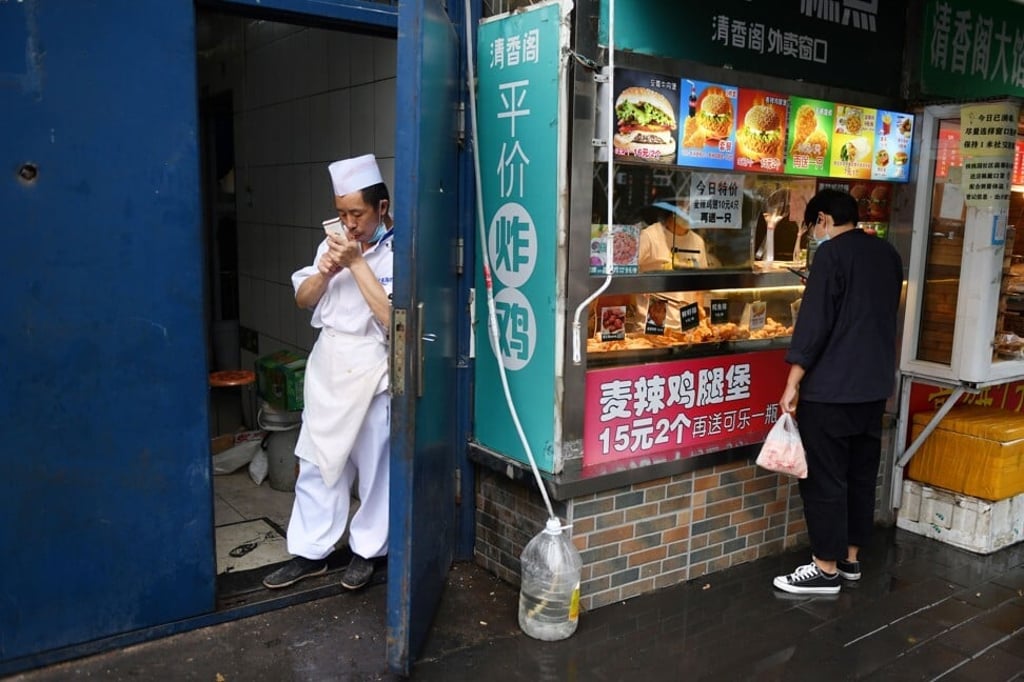 A chef lights up a cigarette in Beijing. The link between poverty and propensity to smoke is not unique to China. Photo: AFP A chef lights up a cigarette in Beijing. The link between poverty and propensity to smoke is not unique to China. Photo: AFP