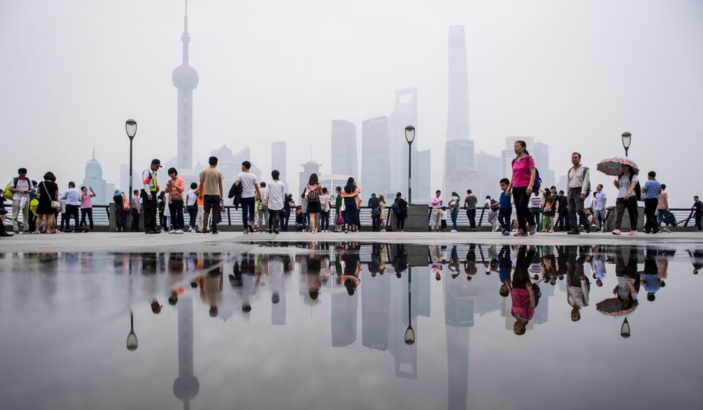 Tourists flock to the promenade on the Bund along the Huangpu River in Shanghai, seen against the skyline of the Lujiazui financial district, in May 2018. Photo: AFP Tourists flock to the promenade on the Bund along the Huangpu River in Shanghai, seen against the skyline of the Lujiazui financial district, in May 2018. Photo: AFP