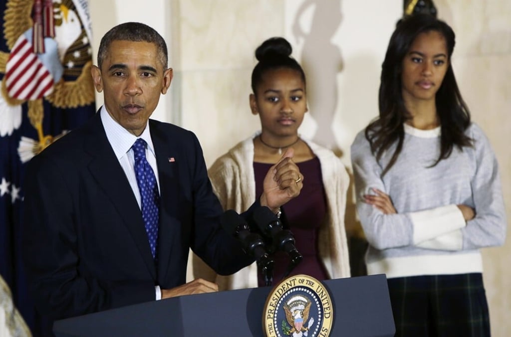 Former US president Barack Obama with daughters Sasha and Malia before pardoning the National Thanksgiving Turkey at the White House in 2014. Photo: Reuters