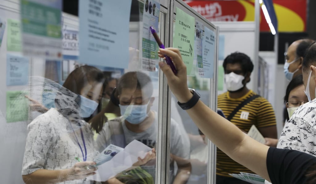Jobseekers fill out application forms at a job fair held by Hong Kong’s Labour Department in October. Photo: Nora Tam Jobseekers fill out application forms at a job fair held by Hong Kong’s Labour Department in October. Photo: Nora Tam