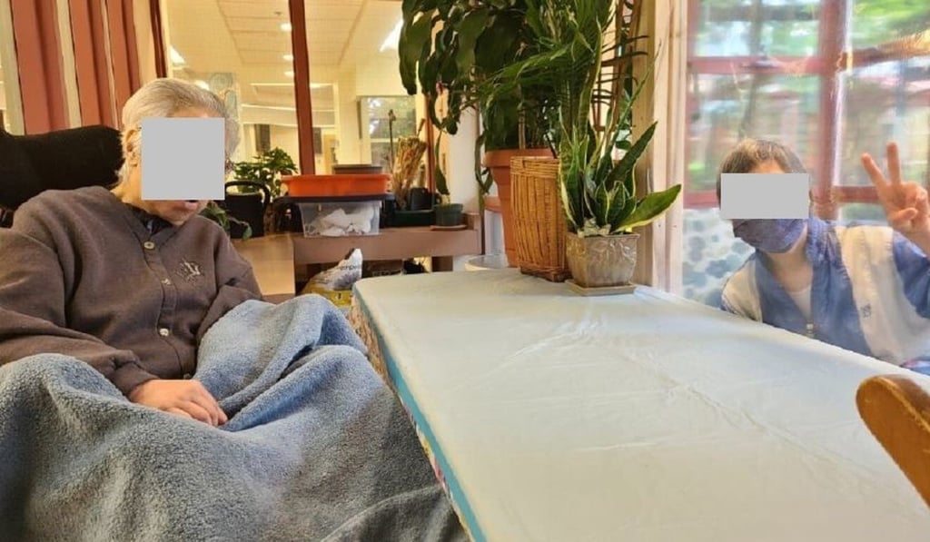 A resident of Little Mountain Place receives a visitor to the care home’s socially distanced reception area, separated by a transparent plastic screen, in a scene depicted in the home’s August 2020 newsletter. Photo: Little Mountain Place
