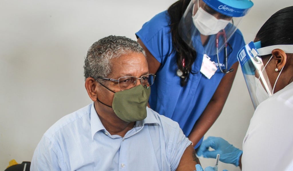 President of Seychelles Wavel Ramkalawan, left, receives the first dose of the Covid-19 vaccine on Sunday. Photo: AFP