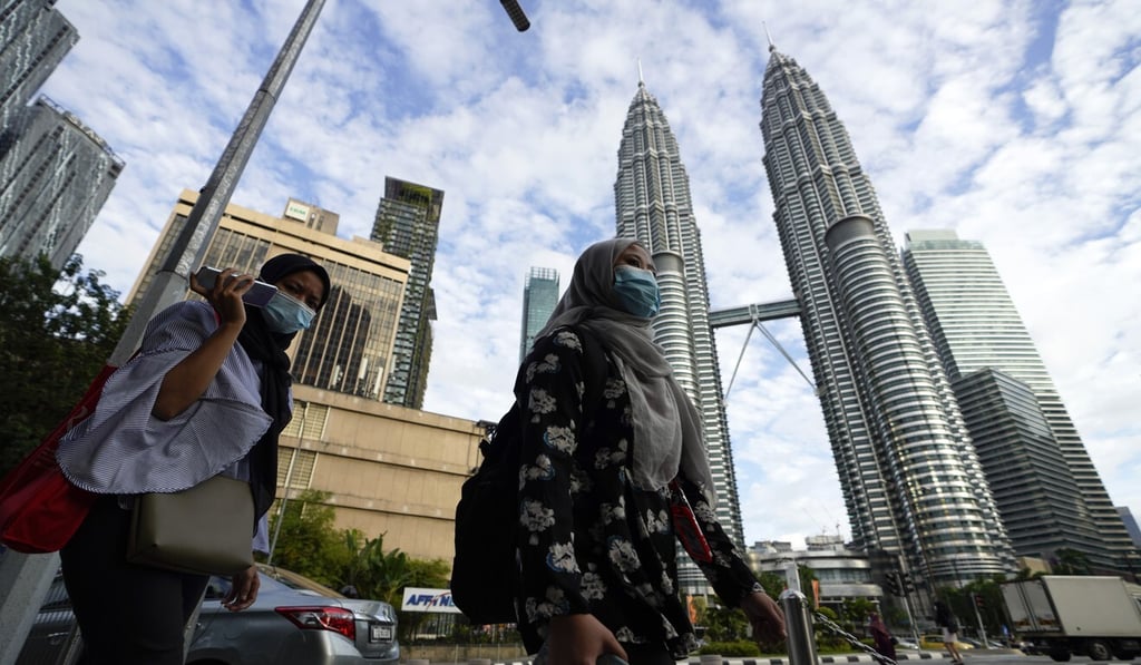 Women wearing face masks in downtown Kuala Lumpur, which will face some of the toughest new lockdown measures. Photo: AP Women wearing face masks in downtown Kuala Lumpur, which will face some of the toughest new lockdown measures. Photo: AP