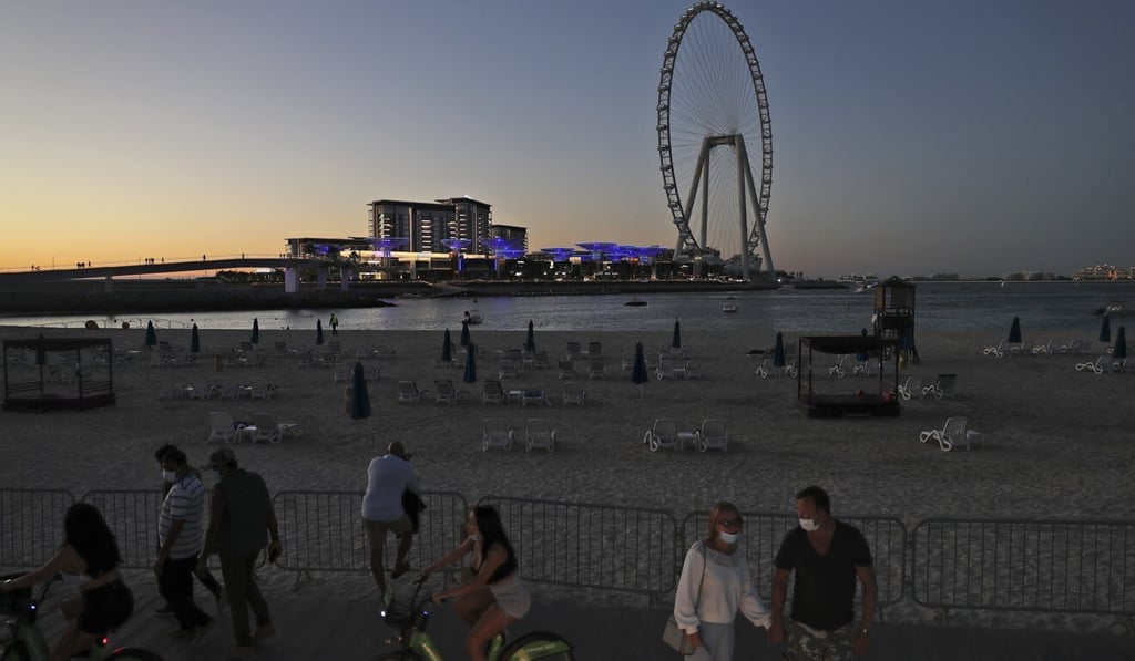Tourists and residents enjoy the sunset at the Jumeirah Beach Residence in Dubai earlier this month. Photo: AP