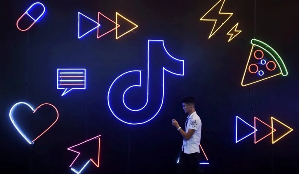 A man holding a phone walks past a sign for ByteDance's Douyin app, the sister app of TikTok, 2019. Photo: Reuters A man holding a phone walks past a sign for ByteDance's Douyin app, the sister app of TikTok, 2019. Photo: Reuters