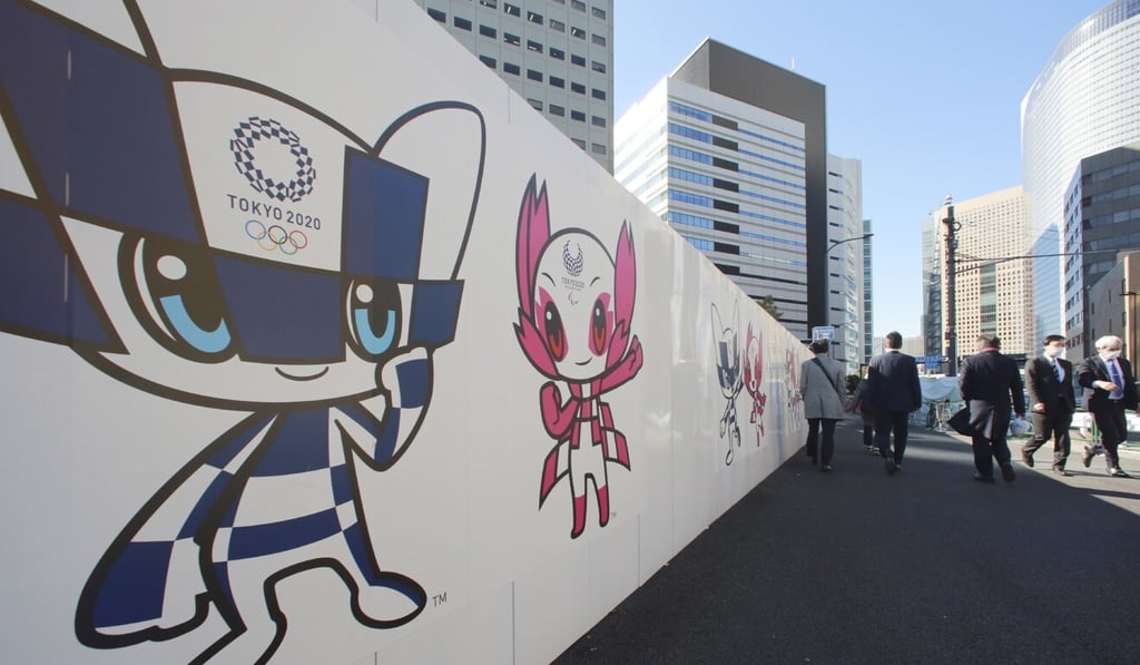 People in Japan walk past posters promoting the Tokyo 2020 Olympics and Paralympics games on Wednesday. Photo: AP
