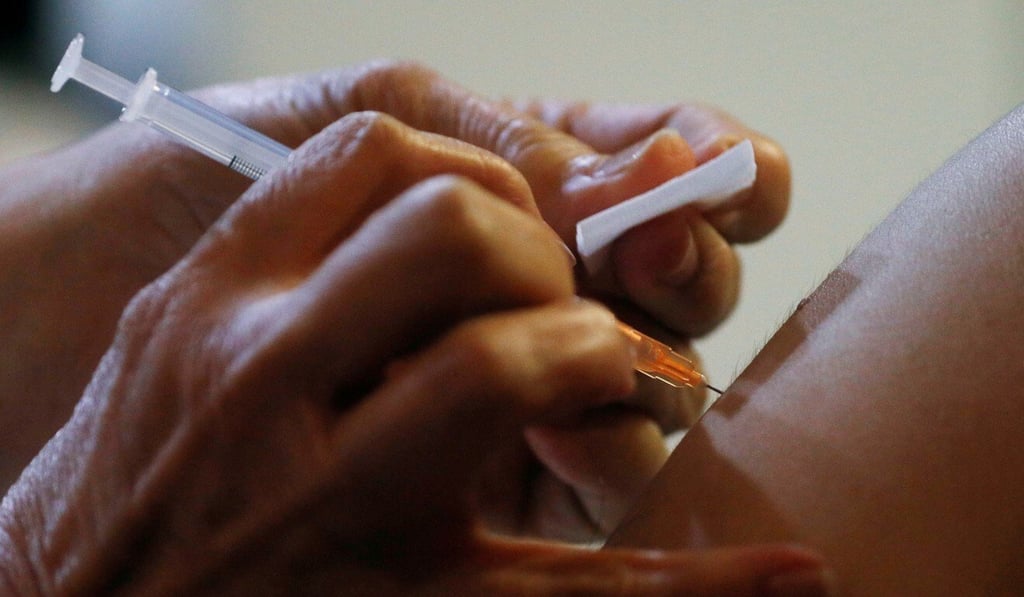 A doctor receives the coronavirus vaccine at Gleneagles hospital in Singapore. Photo: Reuters