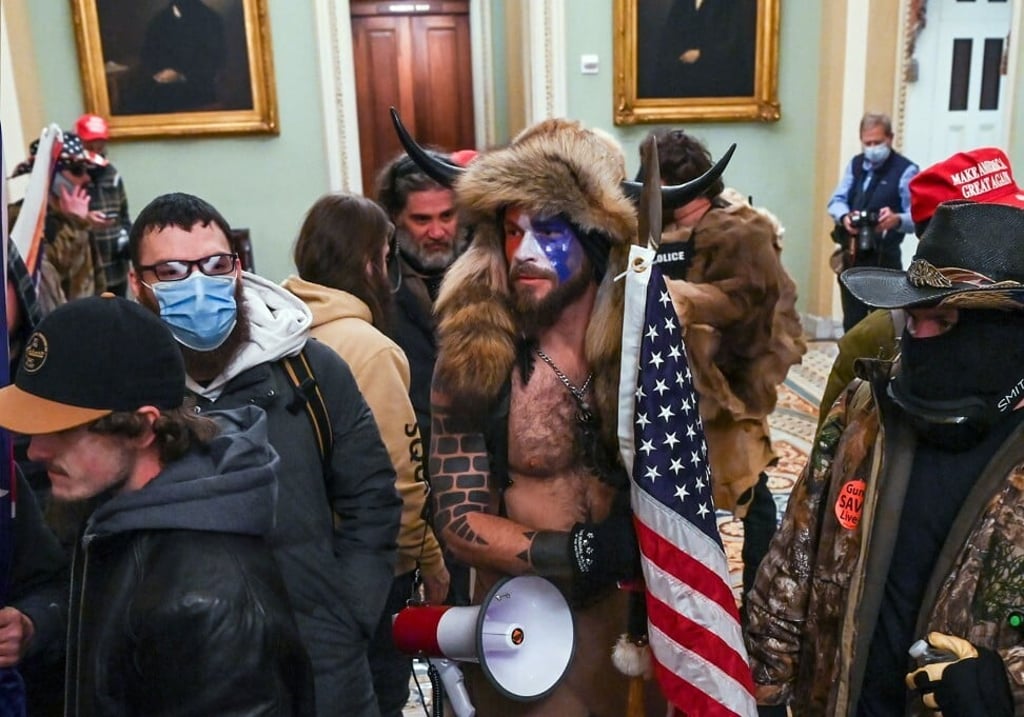 Supporters of Donald Trump, including Jake Angeli (centre), a QAnon supporter, enter the Capitol in Washington, DC on January 6. Photo: AFP