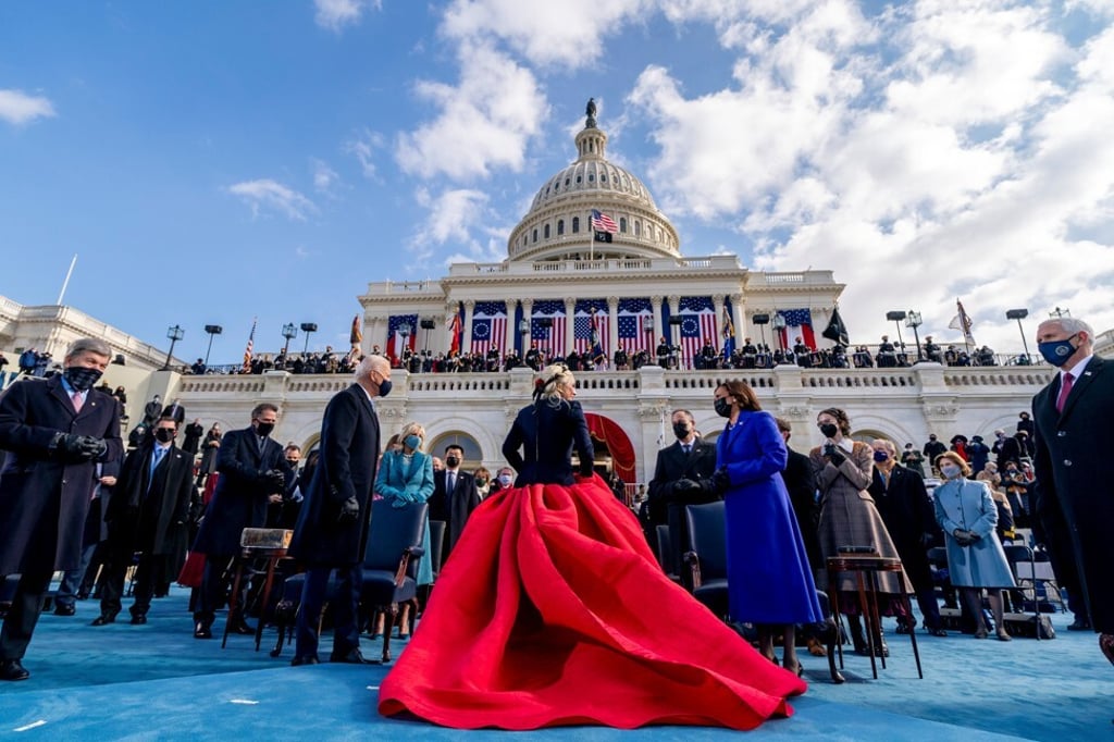 President Joe Biden and Vice-President Kamala Harris speak to Lady Gaga as she departs after performing the US national anthem during the 59th Presidential Inauguration. Photo: Reuters