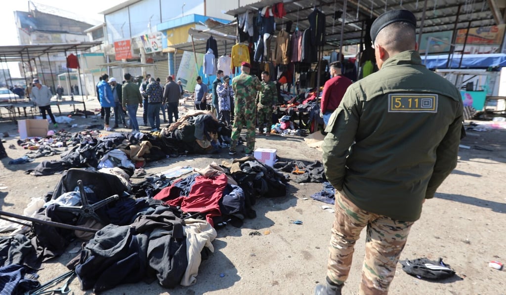 A member of Iraqi security forces walks past the site of one of two bomb explosions in central Baghdad on Thursday. Photo: EPA A member of Iraqi security forces walks past the site of one of two bomb explosions in central Baghdad on Thursday. Photo: EPA