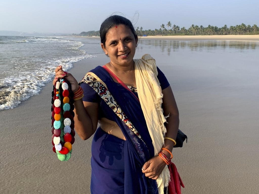 Seema Rajgarh hawks jewellery made of beads and stones on a deserted Utorda beach in South Goa. Photo: AP