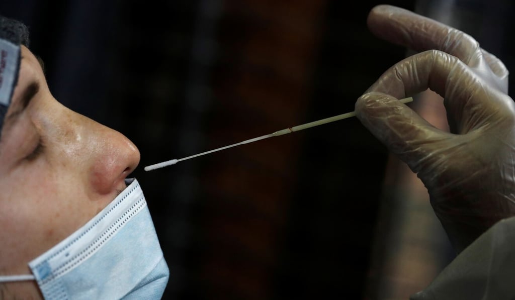 A medical worker takes a nasal swab from a person at a Covid-19 testing centre in Nantes, France, on Friday. Photo: Reuters A medical worker takes a nasal swab from a person at a Covid-19 testing centre in Nantes, France, on Friday. Photo: Reuters