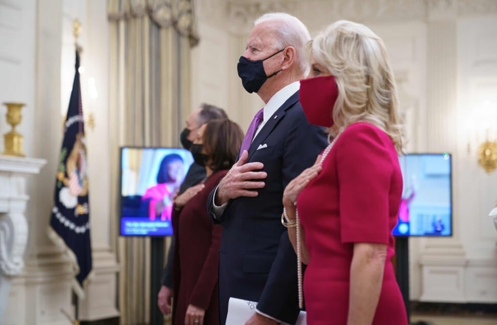 US President Joe Biden and First Lady Jill Biden with Vice-President Kamala Harris and her husband, Second Gentleman Doug Emhoff, listen to the virtual Presidential Inaugural Prayer Service hosted by the Washington National Cathedral in the State Dining Room of the White House in Washington on January 21, 2021. Photo: AFP