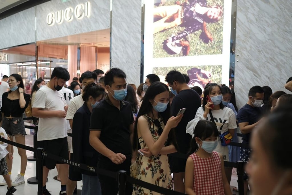 Customers wearing face masks following the Covid-19 outbreak, line up to enter a Gucci store at the Sanya International Duty-Free Shopping Complex, in Sanya, Hainan province, China in August 2020. Photo: Reuters Customers wearing face masks following the Covid-19 outbreak, line up to enter a Gucci store at the Sanya International Duty-Free Shopping Complex, in Sanya, Hainan province, China in August 2020. Photo: Reuters