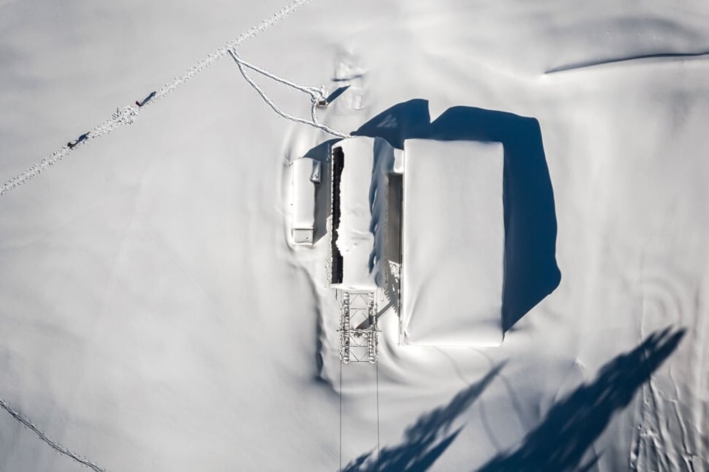 The chair lift station beside the car park stands frozen and unused. Photo: AFP The chair lift station beside the car park stands frozen and unused. Photo: AFP
