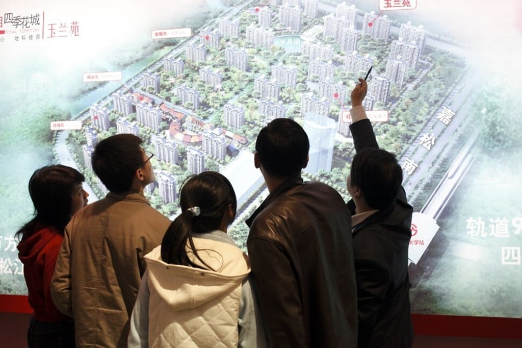 An agent shows potential buyers the layout of a new residential development at a real estate fair in Shanghai on 15 March, 2009. Photo: Corbis via Getty Images An agent shows potential buyers the layout of a new residential development at a real estate fair in Shanghai on 15 March, 2009. Photo: Corbis via Getty Images
