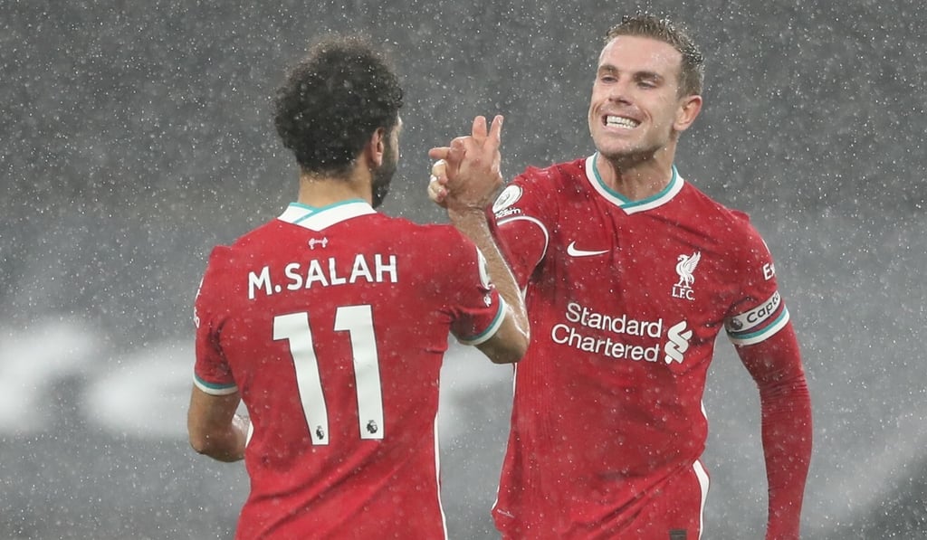 Liverpool’s Mohamed Salah celebrates with captain Jordan Henderson after their win against Tottenham Hotspur at White Hart Lane in London. Photo: EPA
