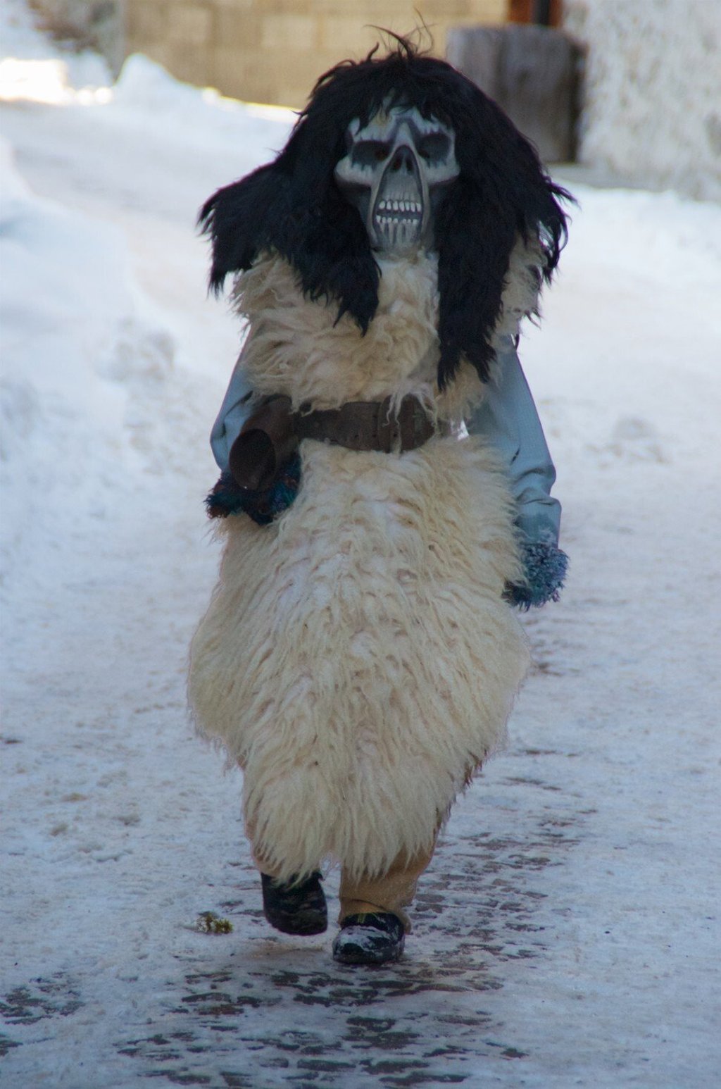 A young Lötschentaler wanders the narrow lanes of the Swiss village of Kippel during the Tschäggättä festival. Photo: Peter Neville-Hadley