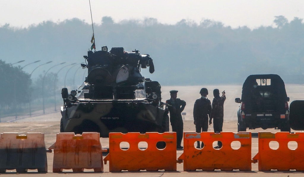 Myanmar's military stand guard at a checkpoint manned with an armoured vehicle on a road leading to the parliament building in Naypyidaw on Tuesday. Photo: AP Myanmar's military stand guard at a checkpoint manned with an armoured vehicle on a road leading to the parliament building in Naypyidaw on Tuesday. Photo: AP
