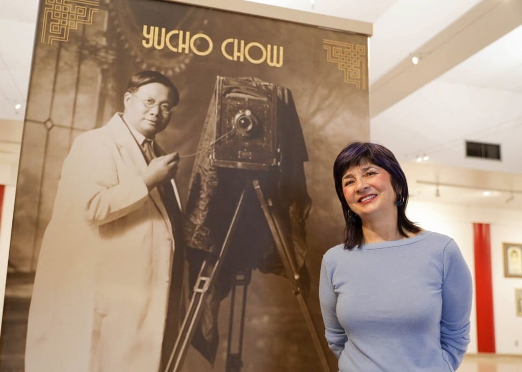 Catherine Clement stands next to a portrait of Canadian-Chinese photographer Yucho Chow. Photo: Herman Thind