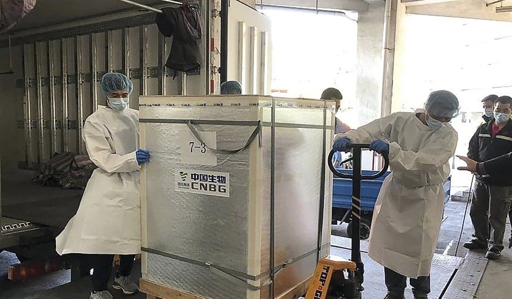 Workers in Macau unload the first batch of Sinopharm vaccines from Beijing on Saturday. Photo: CCTV