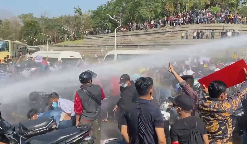 Police fire a water cannon at protesters demonstrating against the coup in Naypyidaw. Photo: Reuters Police fire a water cannon at protesters demonstrating against the coup in Naypyidaw. Photo: Reuters