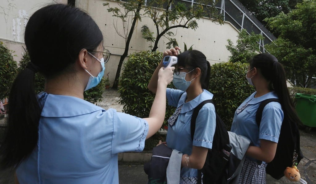 Secondary school students have their temperatures checked before entering campus. Photo: Jonathan Wong Secondary school students have their temperatures checked before entering campus. Photo: Jonathan Wong
