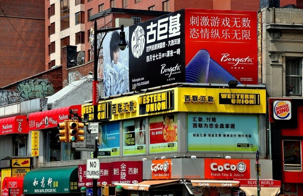 Shops with signs in English and Chinese line the streets of Chinatown in New York City’s Flushing neighbourhood. Photo: Shutterstock Shops with signs in English and Chinese line the streets of Chinatown in New York City’s Flushing neighbourhood. Photo: Shutterstock