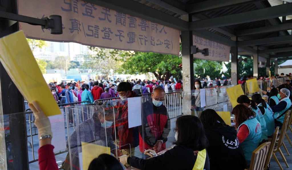 Worshippers registered for contact-tracing via a new government app, their Octopus cards or manually with volunteers at Wong Tai Sin Temple on Friday. Photo: Sam Tsang