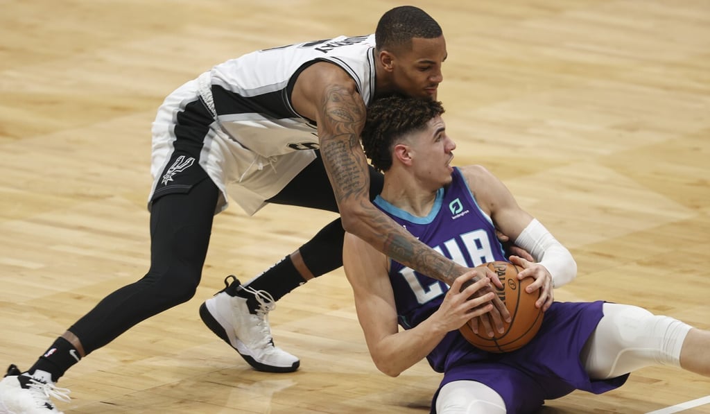Charlotte Hornets guard LaMelo Ball battles San Antonio Spurs guard Dejounte Murray for a loose ball in an NBA game in Charlotte, North Carolina, in February. Photo: AP Charlotte Hornets guard LaMelo Ball battles San Antonio Spurs guard Dejounte Murray for a loose ball in an NBA game in Charlotte, North Carolina, in February. Photo: AP