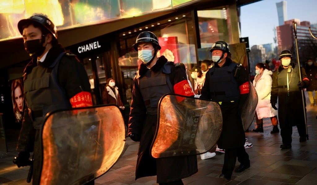 Security guards patrol in a shopping district during the Lunar New Year holiday in Beijing, China on Tuesday. Photo: Reuters