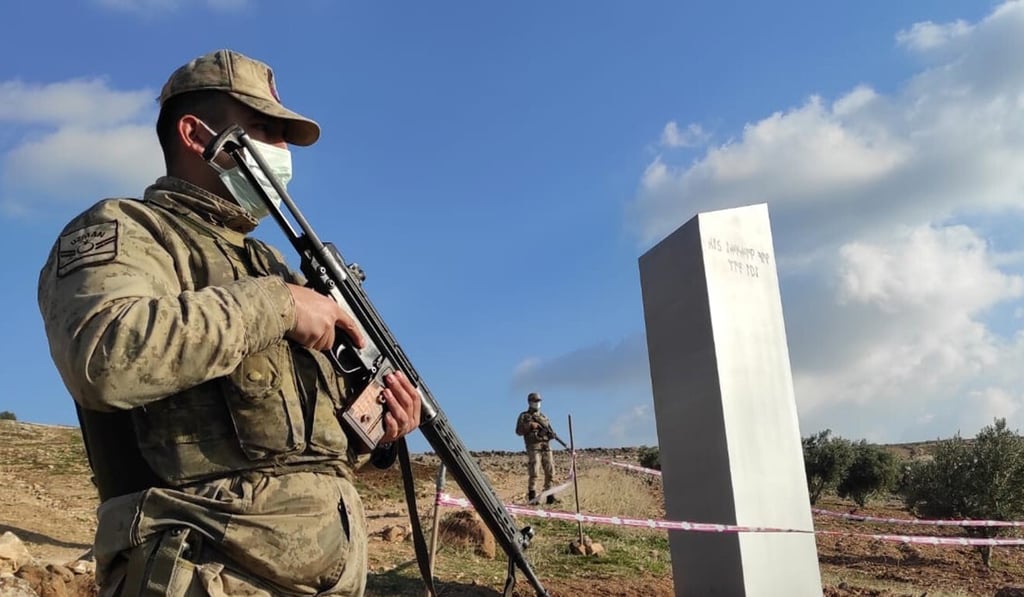 Police officers guard a monolith, found by a farmer in a field in southeastern Turkey, on February 7. Photo: IHA via AP