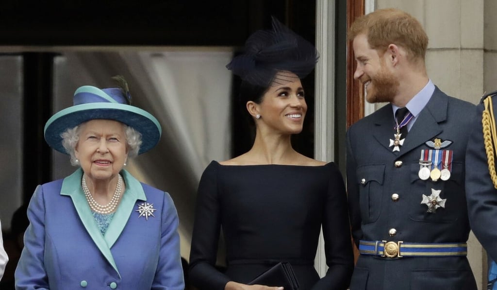 Britain’s Queen Elizabeth, Prince Harry and his wife Meghan watch a fly-past in London. File photo: AP