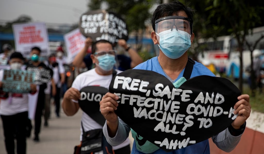 A health worker holds a placard calling for free, safe, and effective Covid-19 vaccines during a protest in Metro Manila on Monday. Photo: Reuters A health worker holds a placard calling for free, safe, and effective Covid-19 vaccines during a protest in Metro Manila on Monday. Photo: Reuters