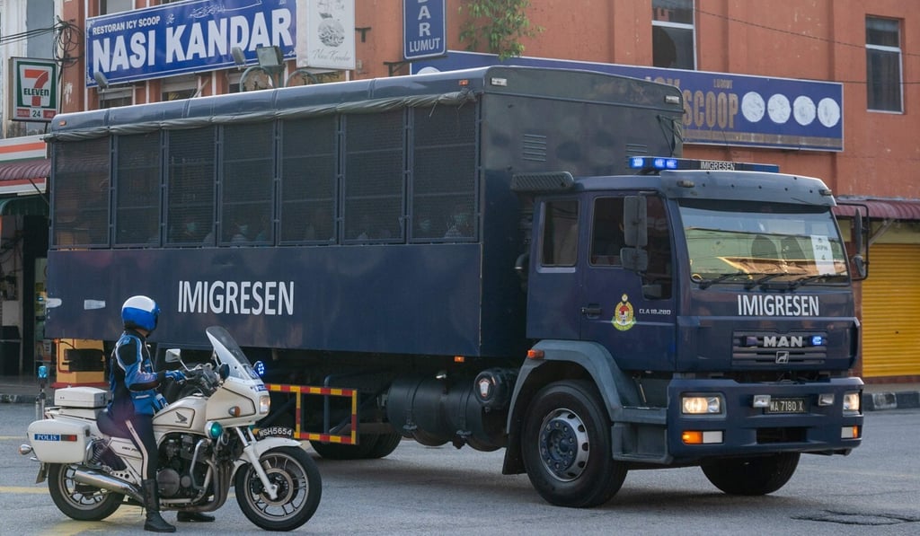 An immigration truck carrying Myanmar migrants is seen heading towards the naval base in Lumut, Malaysia, on Tuesday. Photo: AFP