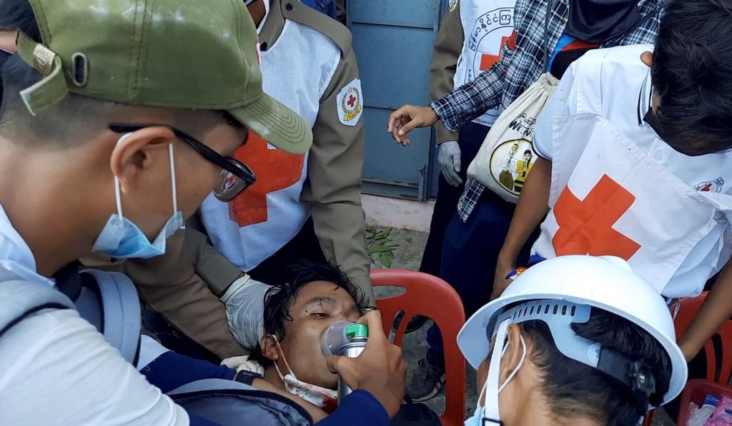 Health care workers treat a man for gunshot wounds in Dawei, Myanmar, on Sunday in this still image from video obtained via social media. Photo: Dakkhina Insight via Reuters