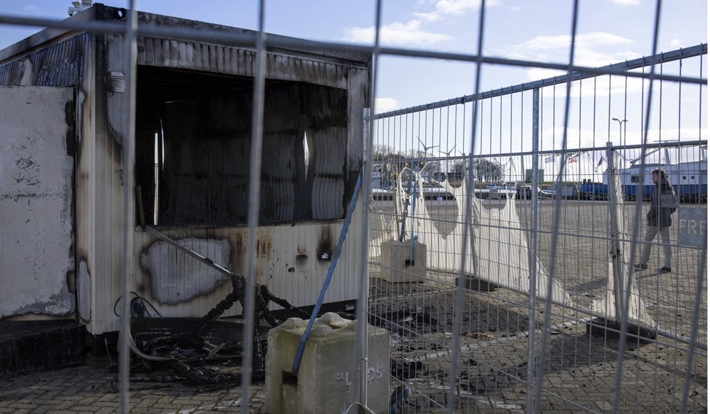 A burned-out coronavirus testing facility in the fishing village of Urk in the Netherlands after it was set on fire the night before by rioting youths protesting on the first night of a nationwide curfew. Photo: AP