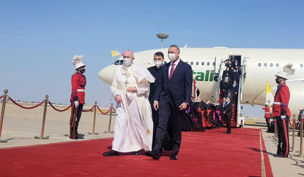 Iraqi Prime Minister Mustafa Al-Kadhimi walks with Pope Francis upon his arrival at Baghdad International Airport. Photo: Reuters