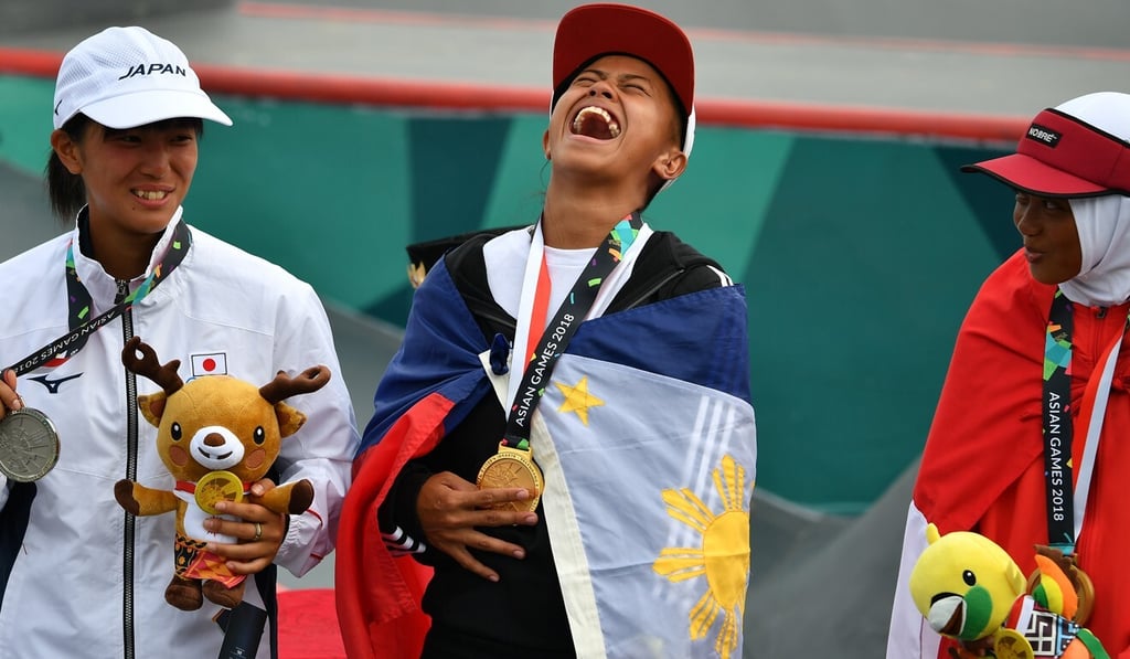 Gold medallist Margielyn Didal celebrates with silver medallist Japan’s Kaya Isa and bronze medallist Bunga Nyimas at the women’s skateboard street event awards ceremony at the 2018 Asian Games. Photo: AFP