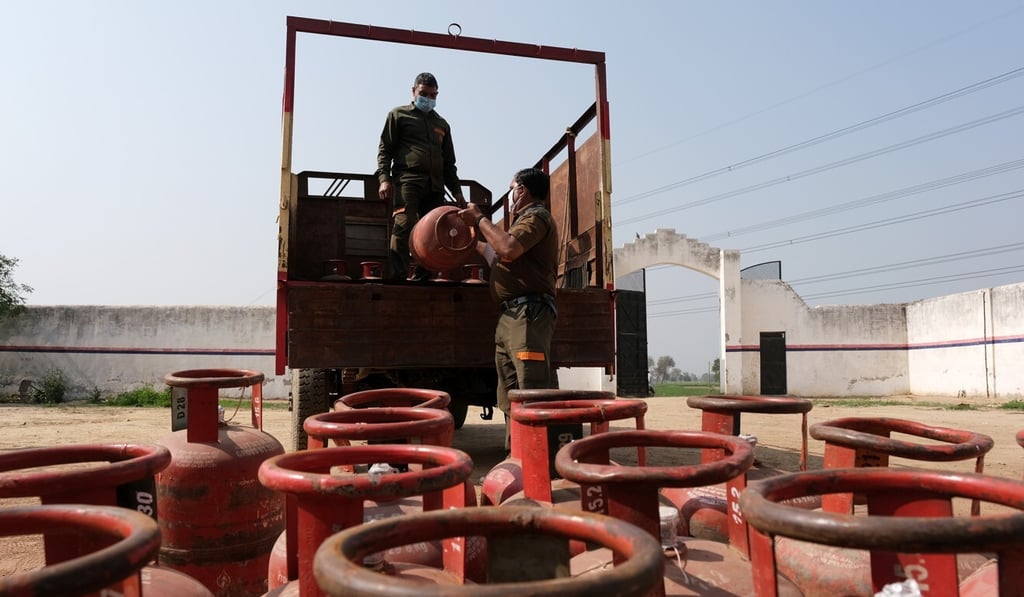 Workers load Indian Oil Corporation liquefied petroleum gas cylinders onto a delivery truck at a village warehouse in Greater Noida, Uttar Pradesh, last month. Photo: Bloomberg