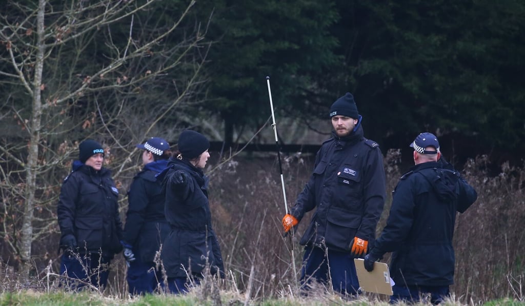 Police officers search woodlands. Photo: DPA
