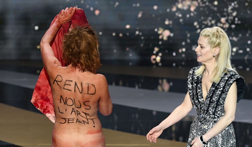 French actress Corinne Masiero takes off her clothes during the Cesar Film Awards ceremony. Photo: AFP