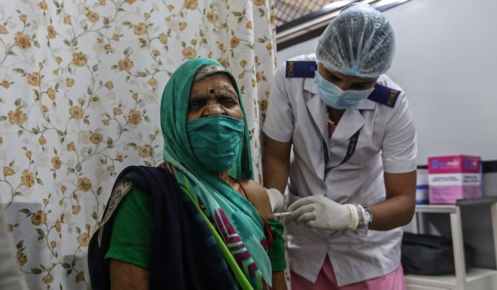 An elderly woman receives her first dose of a Covid-19 vaccine shot in Mumbai, India. Photo: EPA-EFE